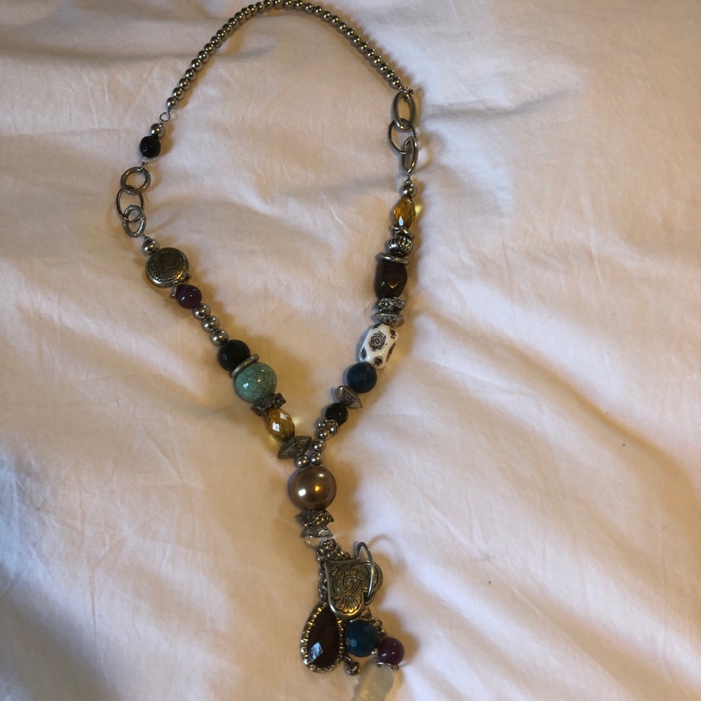 Long silver necklace with beading.